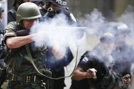 A soldier fires tear gas during a protest by supporters of ousted Honduras President Manuel Zelaya, outside the National Congress in Tegucigalpa, August 12, 2009.